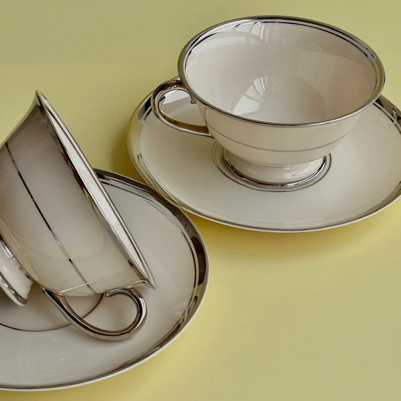 Medieval silver white Medieval coffee cups and saucers with silver edges.