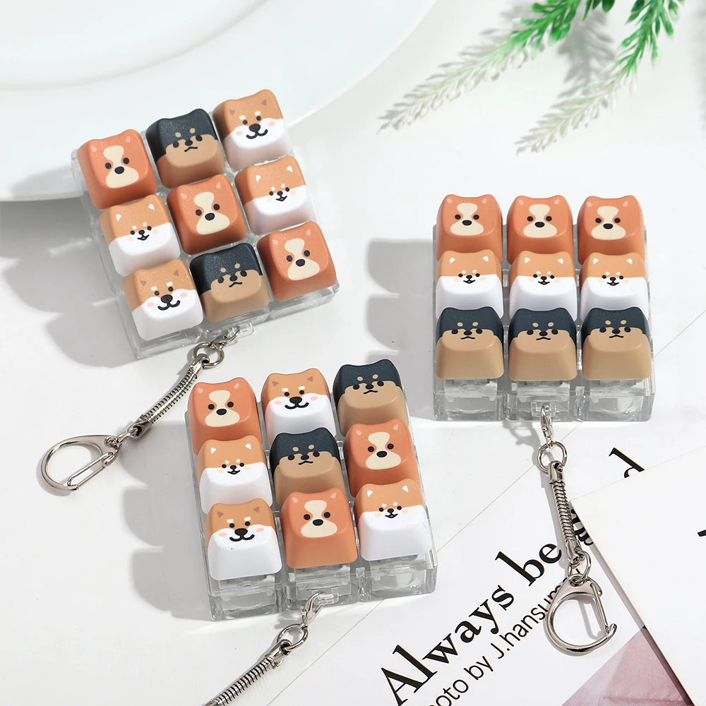 Neue 9-Tasten-Hunde-Finger-Tastatur ohne Beleuchtung, Stressabbau-Fidget-Schlüsselanhänger, Zeitvertreib-Tastenknopf, Quetschspielzeug für Erwachsene