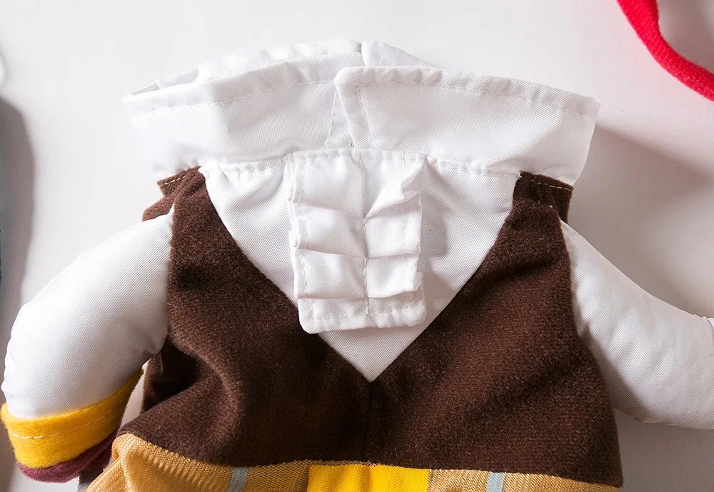 A close-up of a doll in the KittyNook Cat Co. Funny Pirate Cat Halloween Costume: brown vest and white hooded jacket.