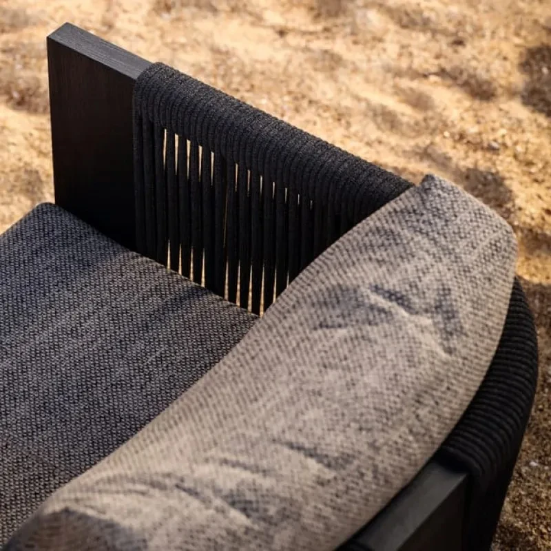 Outdoor garden armchair made of teak wood and woven acrylic, the fabric used for the cushions is waterproof and UV resistant.