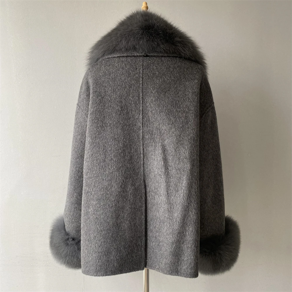 Close-up of covered button closure on wool coat