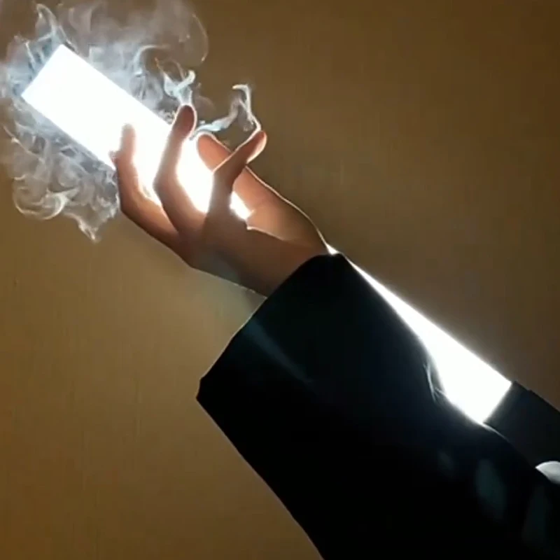 Smoke appearing from fingertips during a magic trick