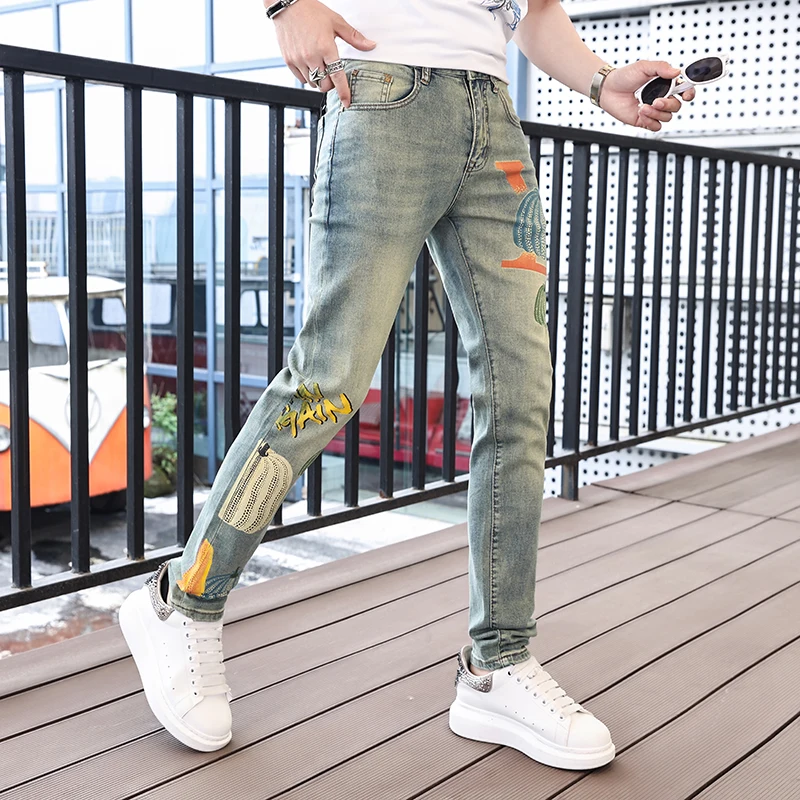 Personalized street fashion pumpkin print men's jeans 2024 spring and summer trend retro casual elastic slim tapered pants