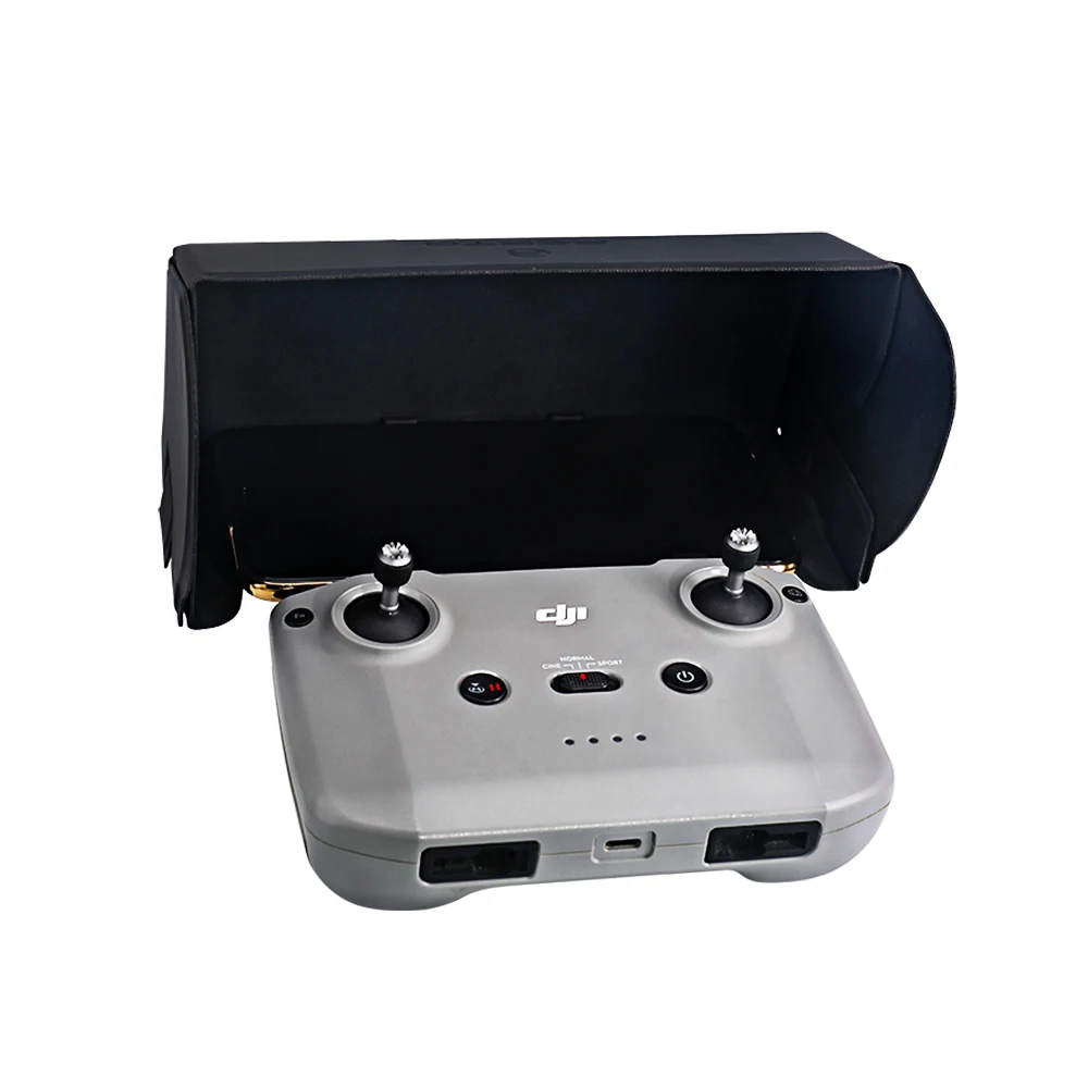 Capot magnétique pour télécommande DJI Air 2S, Mavic Mini 2, Air 2 posé à côté de la télécommande, prêt à être installé