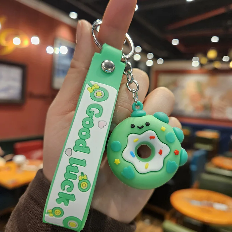 thumbnail image 1 of Llavero creativo con forma de donut de PVC de goma suave con forma de dinosaurio para coche, colgante de bolso para niños kawaii, accesorios de cumpleaños, 1 of 5