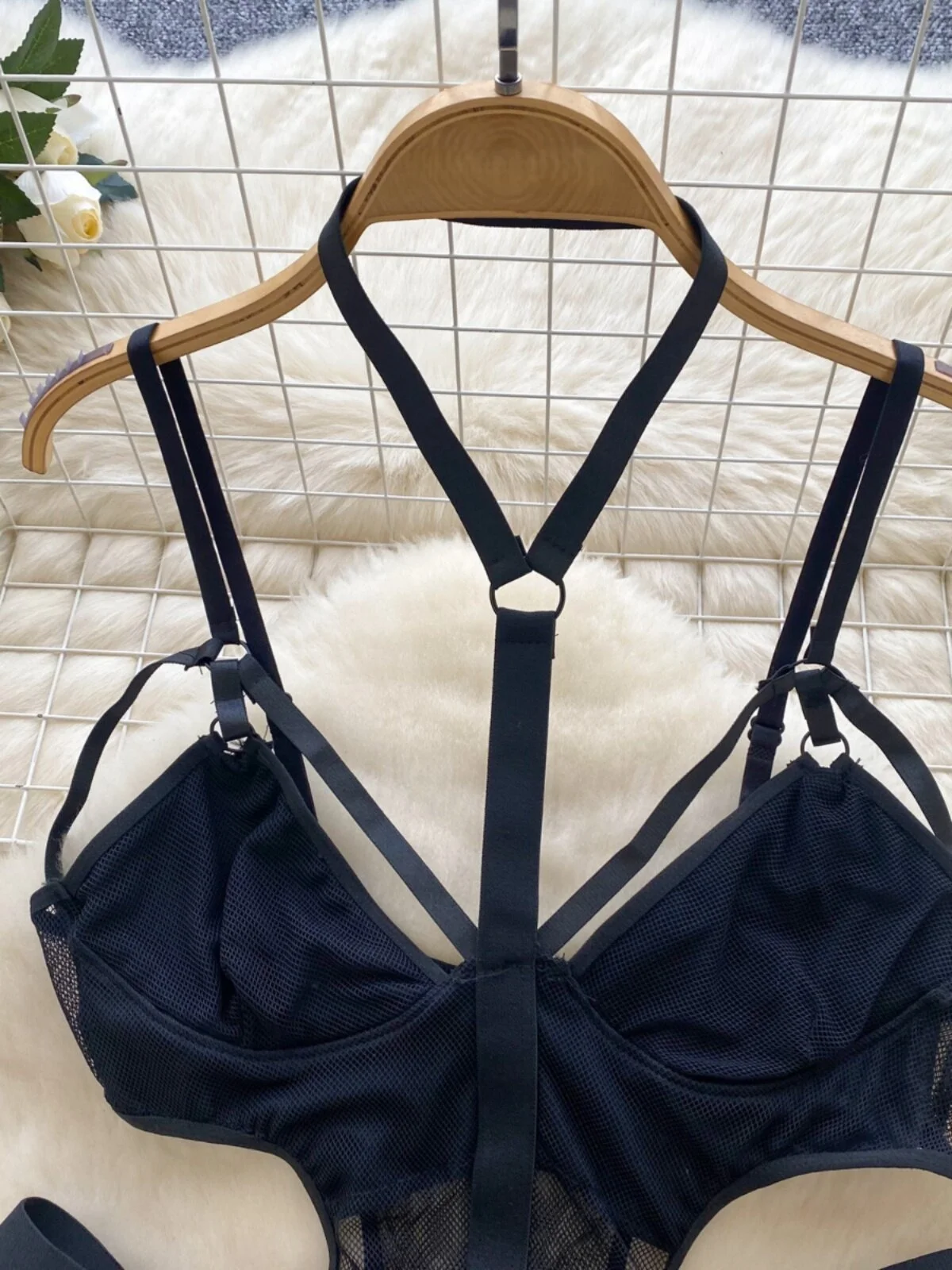 elegant lingerie bodysuit laid flat on white faux fur