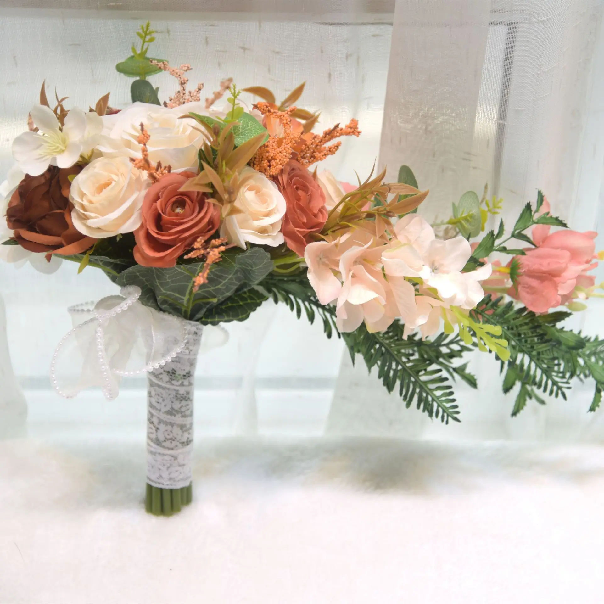 Water droplets from waterfall, bride and bridesmaid holding flowers, wedding gift