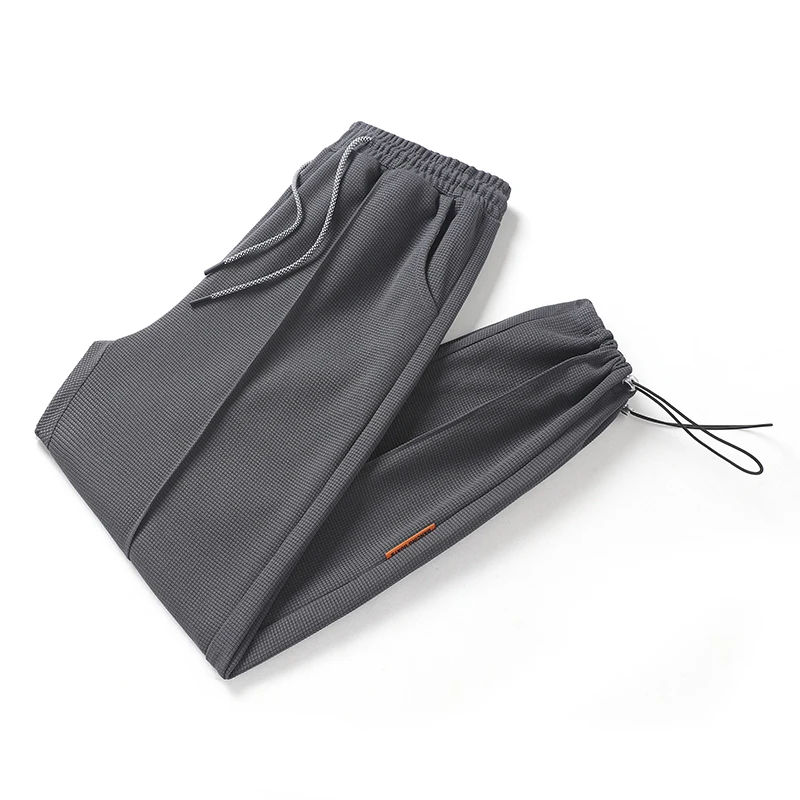 

2024 New Korean Autumn Solid Men's Waffler Elastic Waist Drawstring Pocket Bound Feet Fashion Versatile Casual Loose Sweatpants