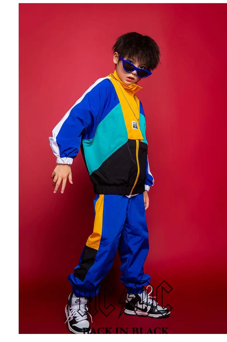 Child wearing patchwork jacket and joggers in hip hop street dance pose 1236