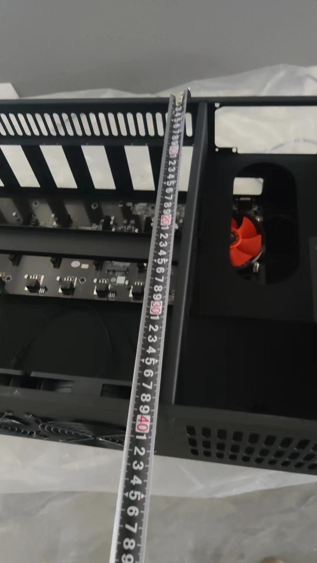 A set of eight PCI card slots in a miner's chassis. The mainboard model is ETH B85 V2.11. There is one fan on the mainboard