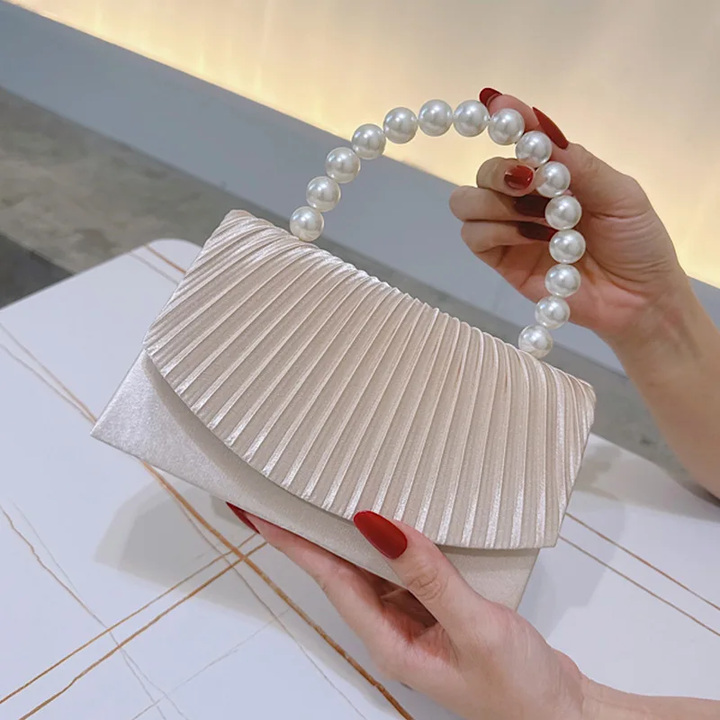 Elegant satin tote bag with pearl handle and ruffled edge design suitable for formal dinners and birthday parties