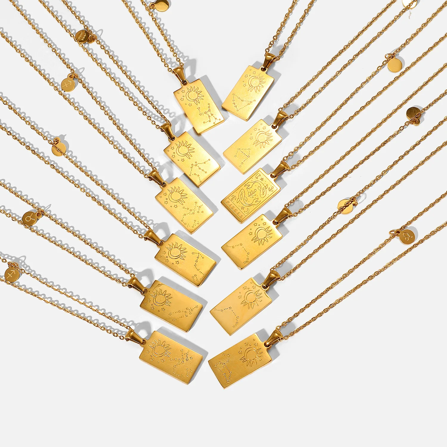 Vintage stainless steel rectangular pendant necklace on a gold link chain.