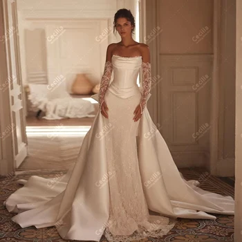 Abiti da sposa glamour Abiti da sposa in raso Applicazioni in pizzo Senza maniche Scollo a barca senza schienale Abiti da sposa personalizzati di lusso