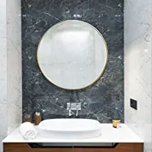 round gold mirror in bathroom