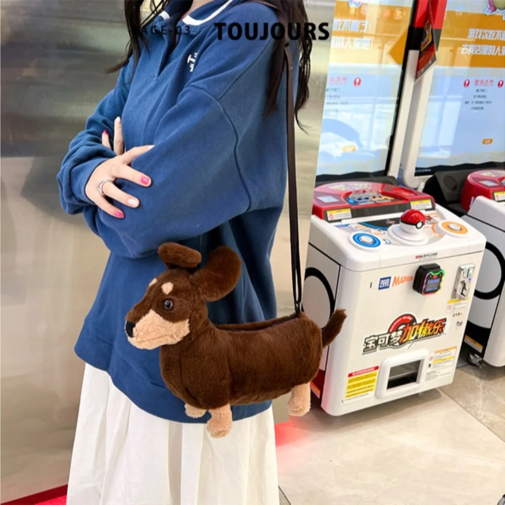 An adorable 3D brown plush Dachshund dog crossbody shoulder bag worn casually by a woman.
