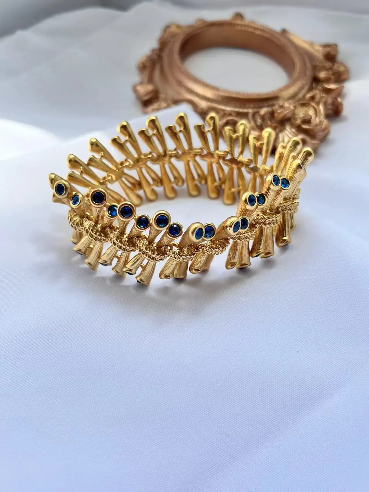 

Medieval style bracelet inlaid with aquamarine zircon texture
