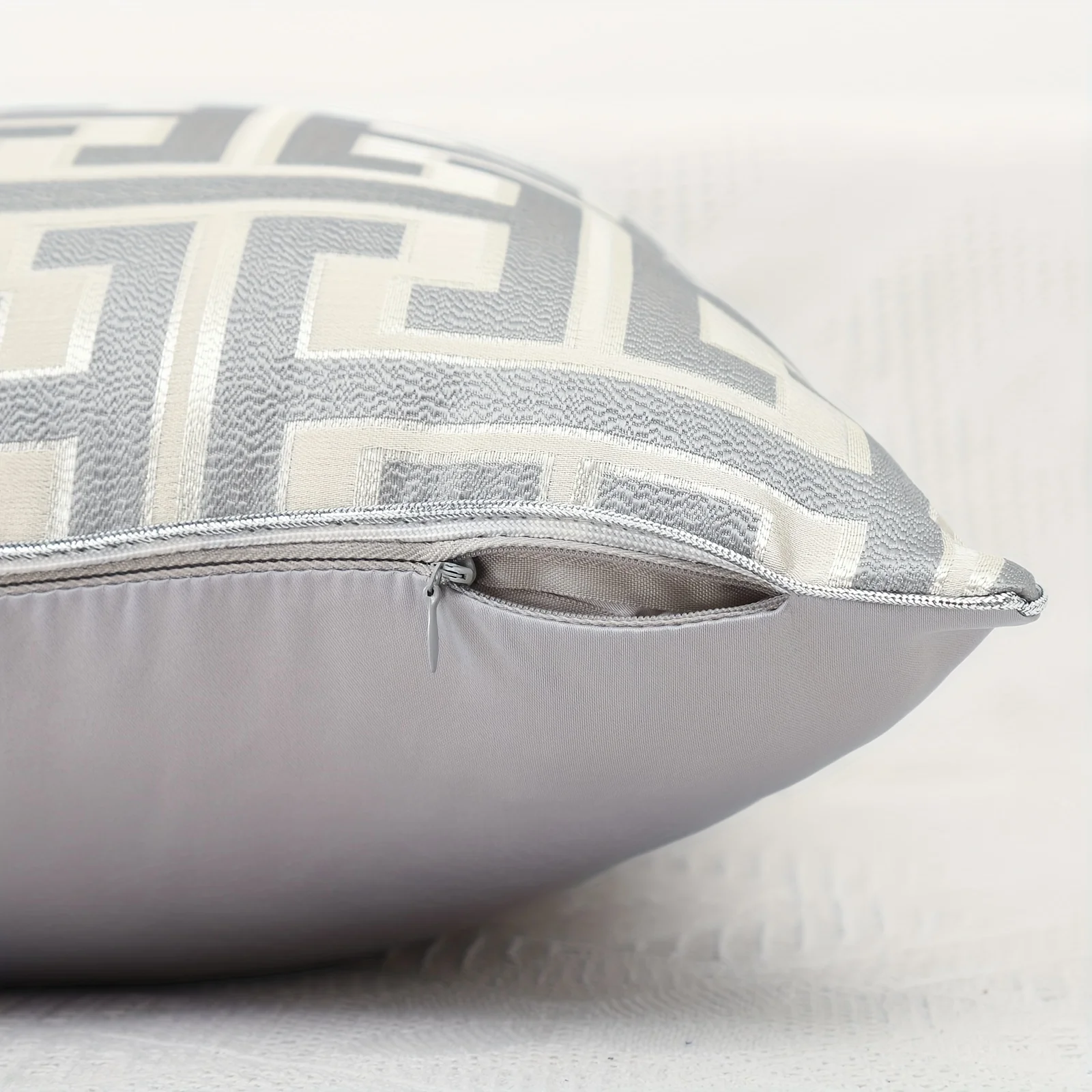 Close-up of concealed zipper and geometric jacquard fabric