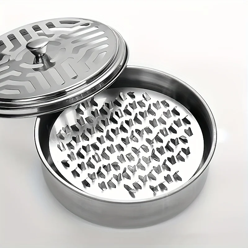 Stainless steel mosquito coil holder with lid on a table