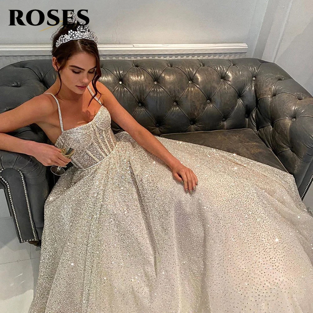 

Glitter Wedding Dress Backless Bride Dress Boned Bruidsjurken A Line Shiny Tulle Spaghetti Straps Beaded Long Tail Bride Gowns