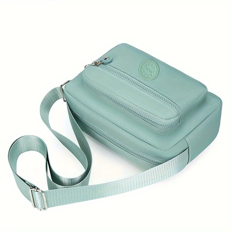 Lightweight Nylon Chic Crossbody Bag for Women - Adjustable Strap, Zip Closure, Tassel Accent, Solid Color