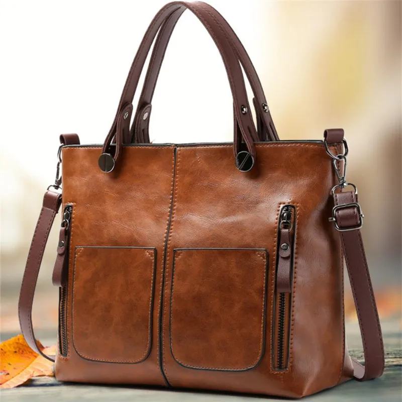 Retro leather handbag with two zipper pockets, versatile tote and crossbody style, classic women’s work and business bag.