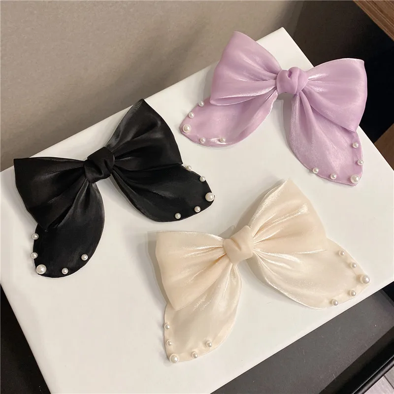 

The texture is full of Korean pendant, smooth and temperament, all-match pearl net red big bow spring clip top clip hairpin