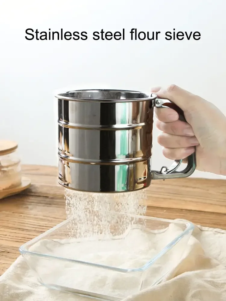 Stainless steel hand-press flour sifter with ergonomic trigger handle.