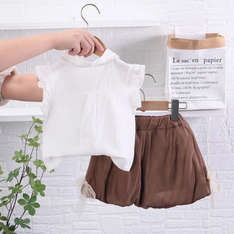 Adorable toddler girl 2-piece outfit featuring a bow top with flying sleeves and matching shorts, perfect for girls aged 0-4 years.
