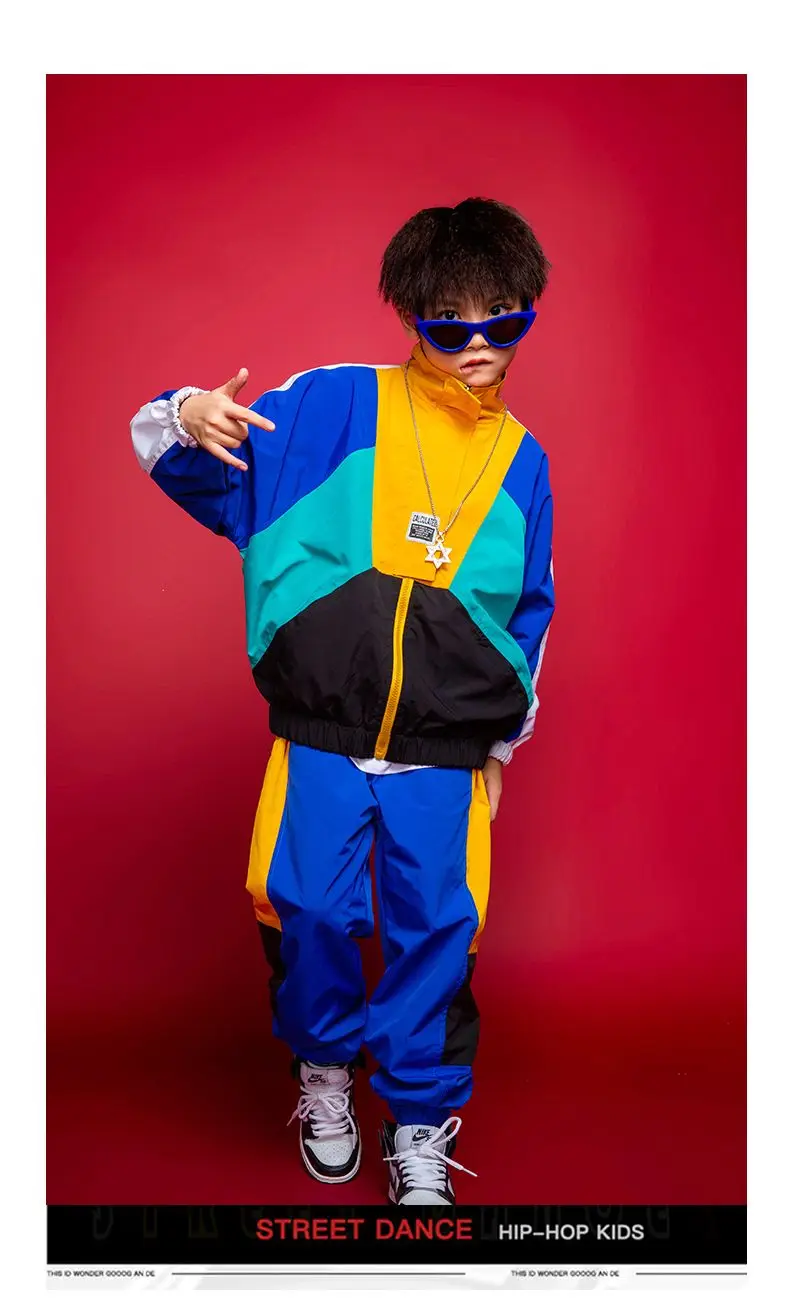 Child wearing patchwork jacket and joggers in hip hop street dance pose45