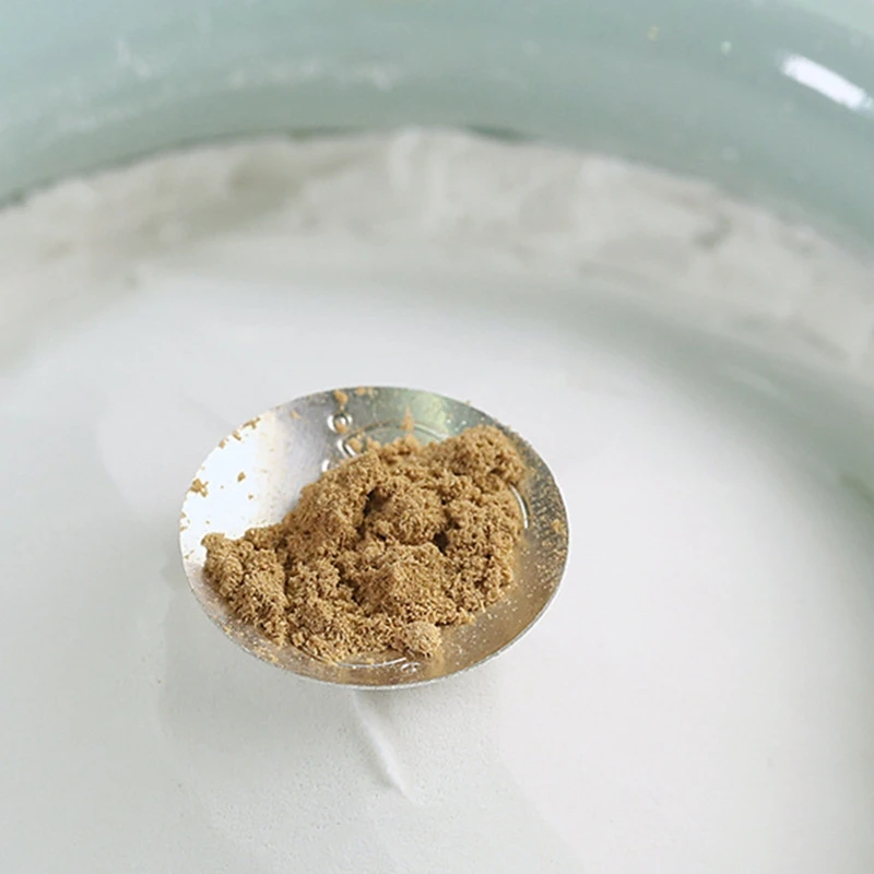 Small spoon holding natural incense ash