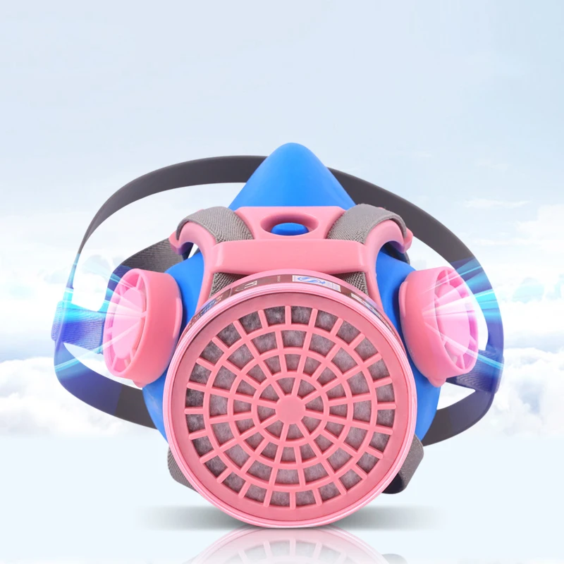 Demi-masque de protection respiratoire avec cartouches filtrantes, vue latérale mettant en évidence la fixation des cartouches.