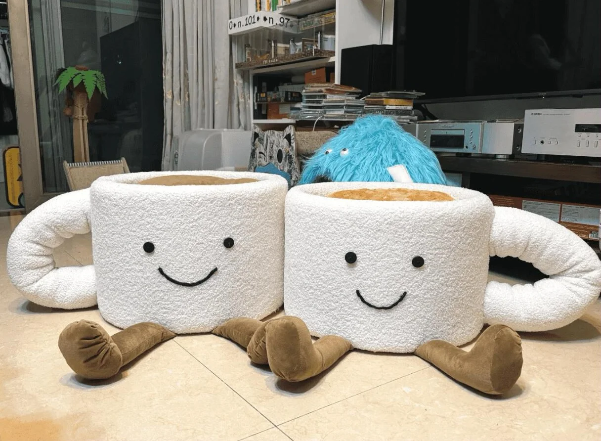 Oversized white coffee mug cute cat bed with stitched smiling face and plush brown legs.