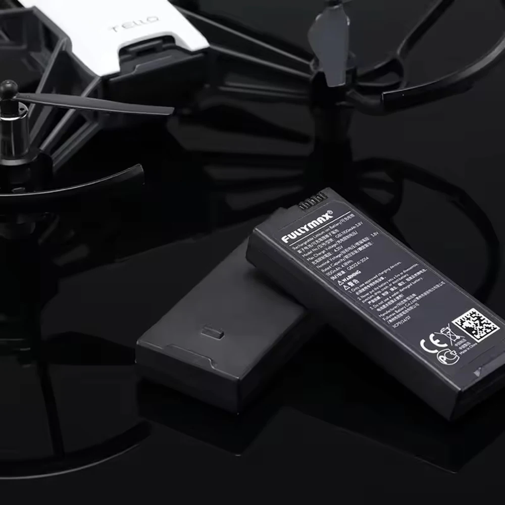 Deux batteries DJI Tello originales côte à côte, emballage blister transparent.