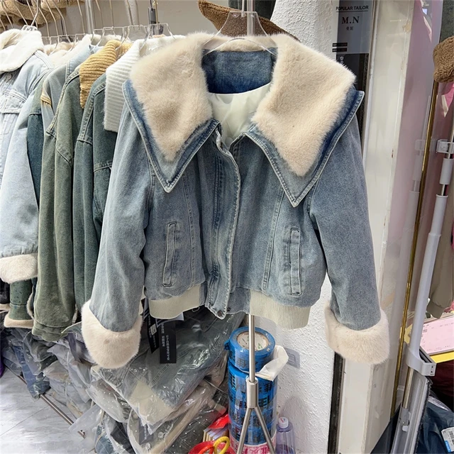 Women's winter clothing store. Jean and cotton clothes hanging on