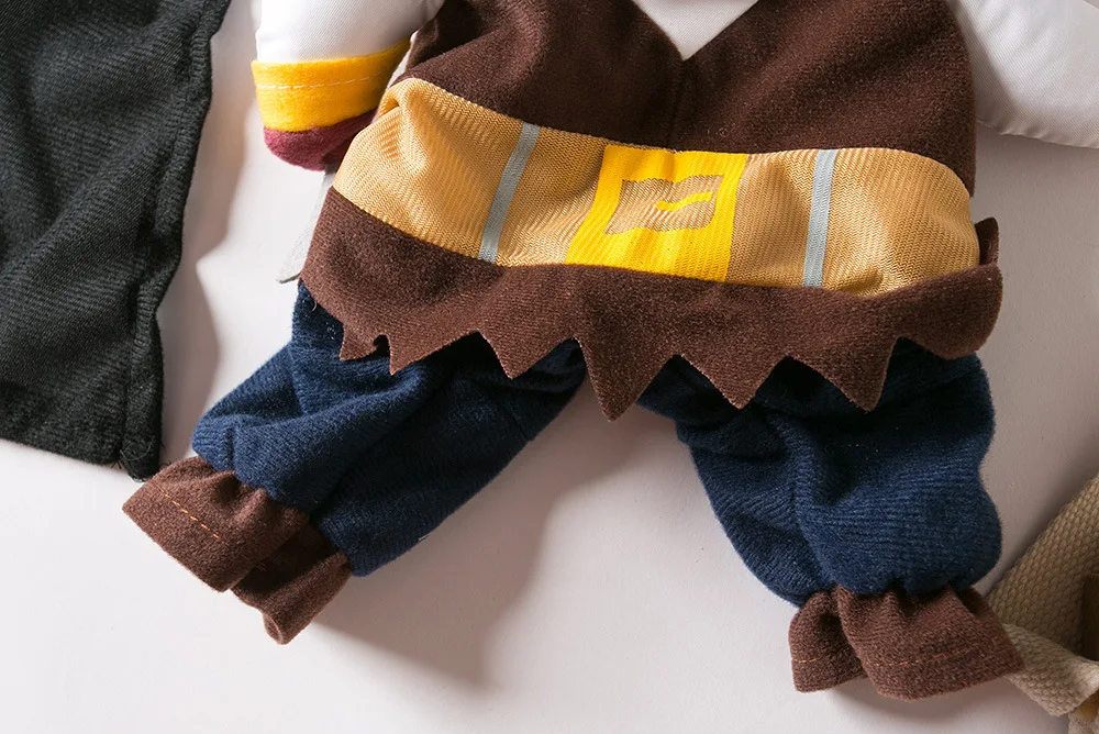 Close-up of KittyNook Cat Co.'s Funny Pirate Cat Halloween Costume on a small doll in brown, yellow, and blue.