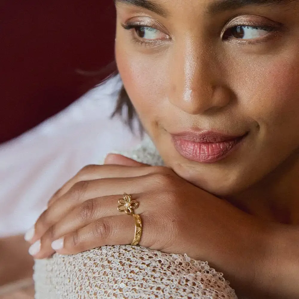 Ring worn on finger showcasing elegant floral design