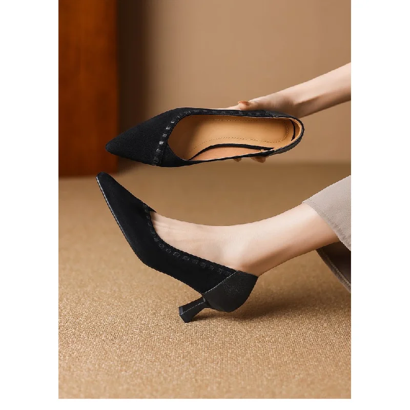 Black Pointed Toe Kitten Heel Pumps Side View Black pointed toe kitten heel pumps worn on foot over beige carpet