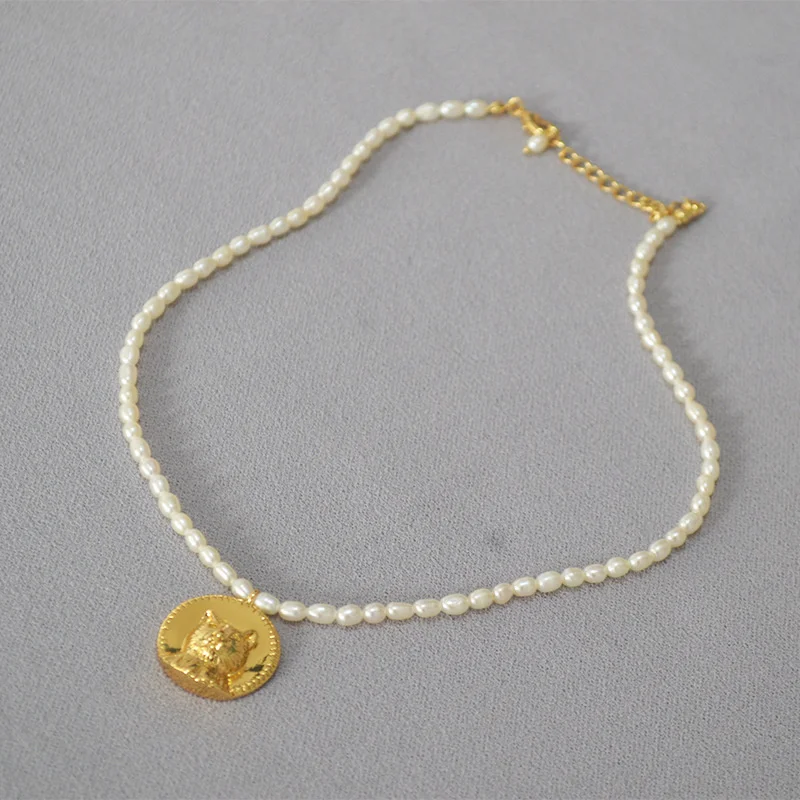 

Design a gentle, domineering and cute little cat head gold coin pendant with freshwater rice bead short necklace collarbone