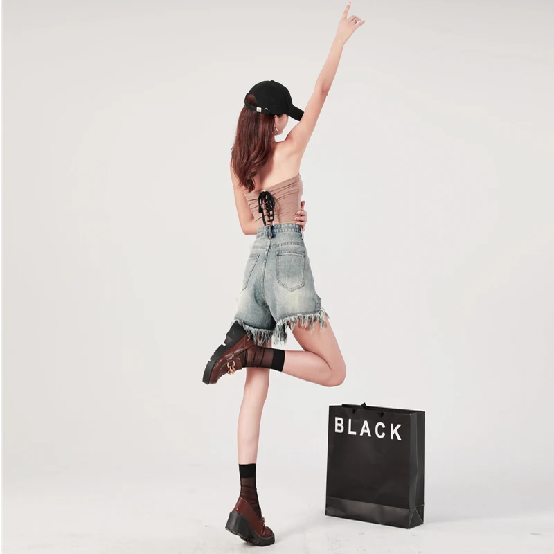 Hot selling vintage distressed rough edge denim shorts for 2023 women's summer loose fitting slim high waisted A-line hot pants