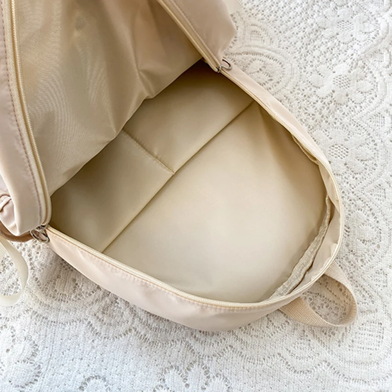 Stylish kawaii backpack with bowknot detail, designed for women and girls, featuring soft pastel tones and spacious compartments for school essentials. inside