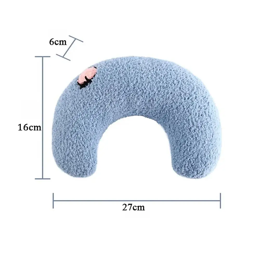 Small dachshund puppies and kittens sleeping comfortably cradled inside pastel-colored U-shaped teddy fleece pet pillows with embroidered floral details.