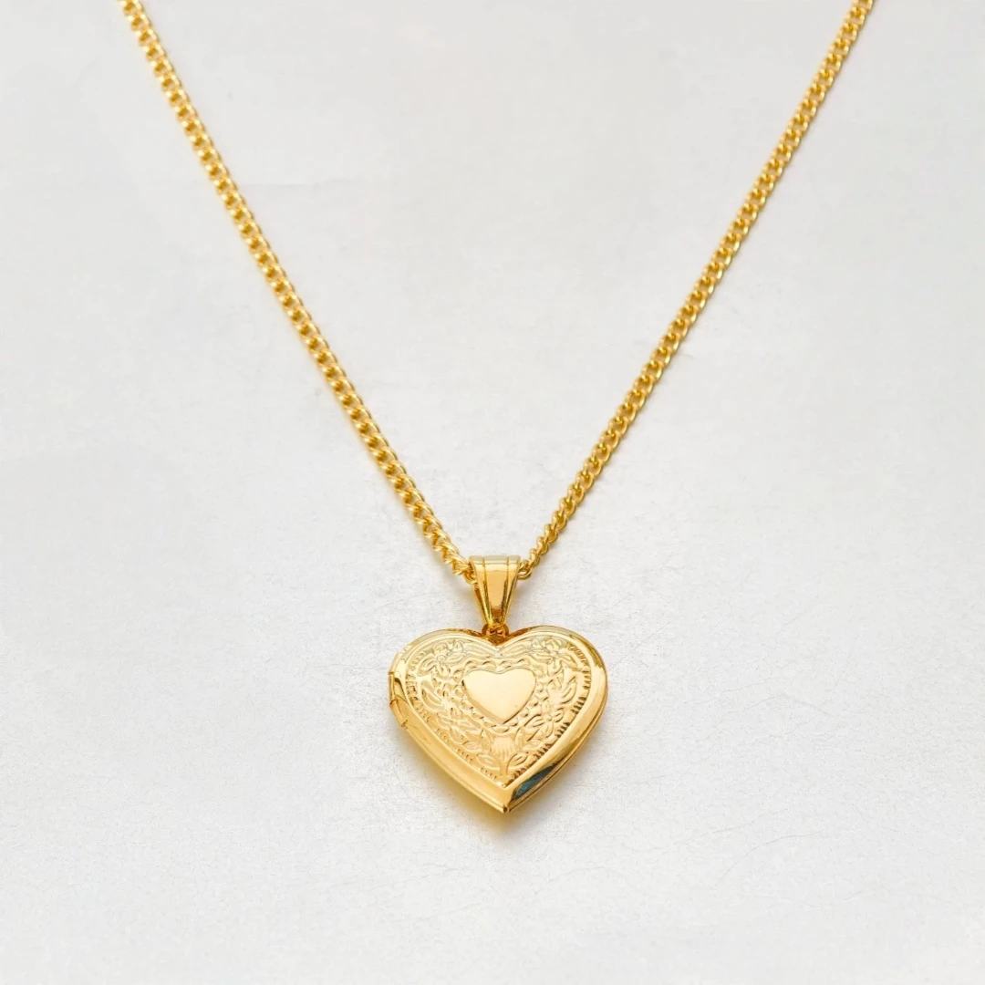 Heart locket necklace worn around model’s neck