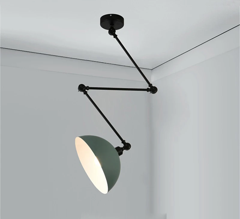 The Zig Zag Pendant Light, featuring an industrial design with a black finish, gray shade, and adjustable arm system, is installed in a corner.