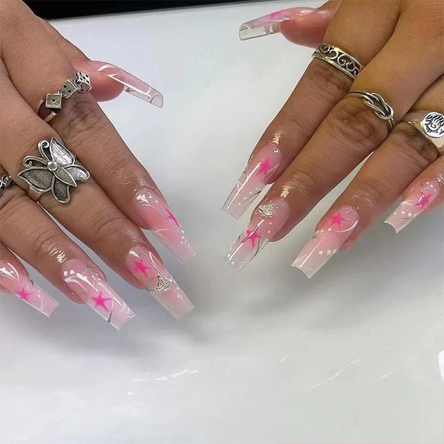 These press-on false nails are a trendy throwback to the Y2K era with their pink color and silver line designs. The coffin shape adds a modern twist to the nostalgic design, making them the perfect accessory for any Y2K-inspired look.