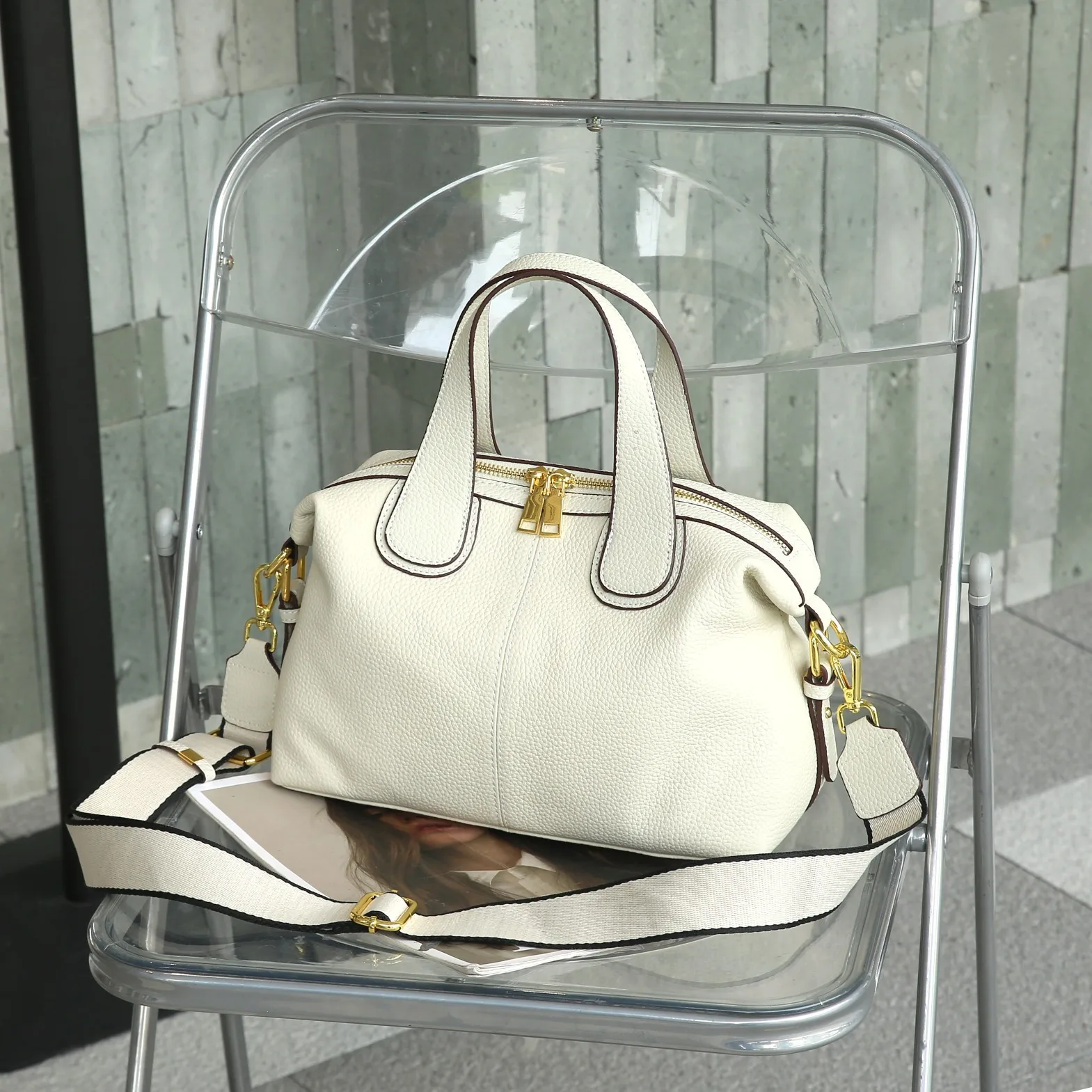 Elegant genuine leather crossbody handbag with shoulder strap and quality details