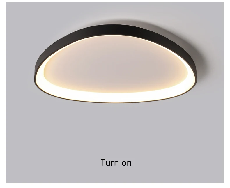 The Nordic Minimalist Ceiling Light is illuminated, casting a soft white glow. It features a round design with a dark outer rim and offers dimmable brightness for precise color temperature control.