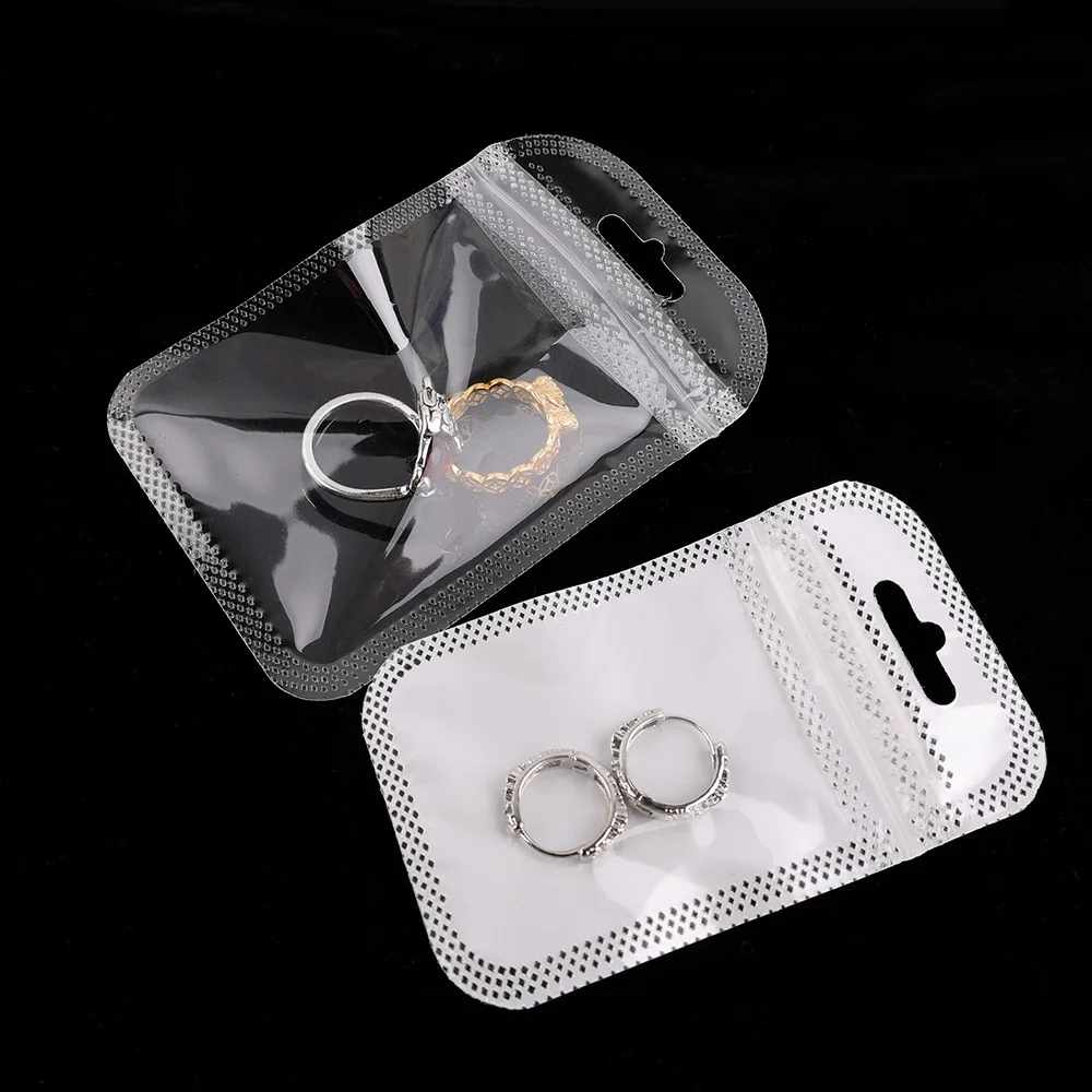 50pcs Thicken Resealable OPP 가방 레이저 무지개 빛깔의 가방 DIY 쥬얼리 만들기위한 교수형 구멍이있는 명확한 저장 가방 흰색 가방