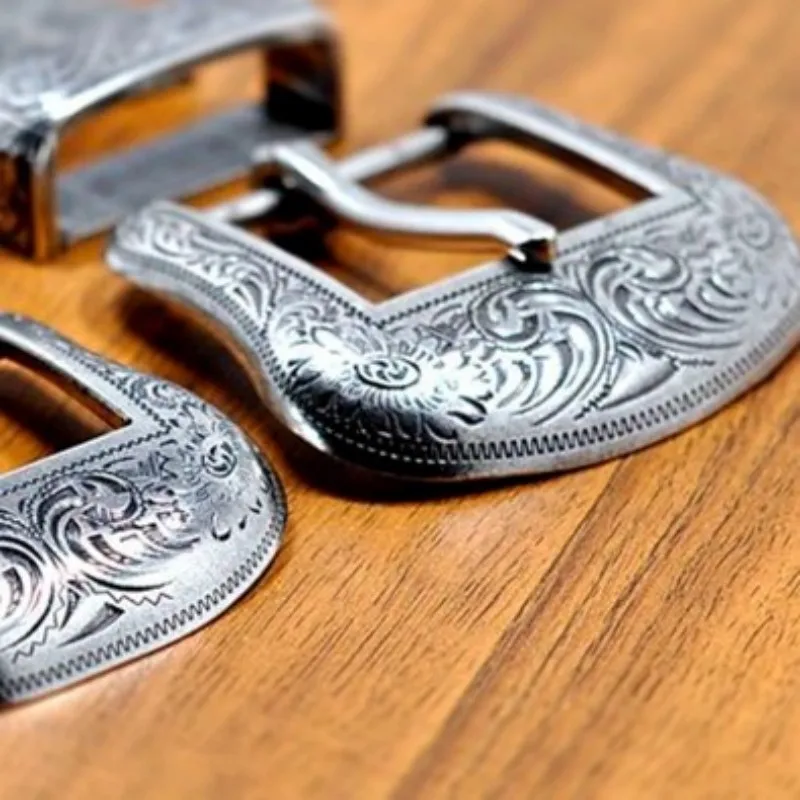 Lot - Four antique sterling silver monogram belt buckles.