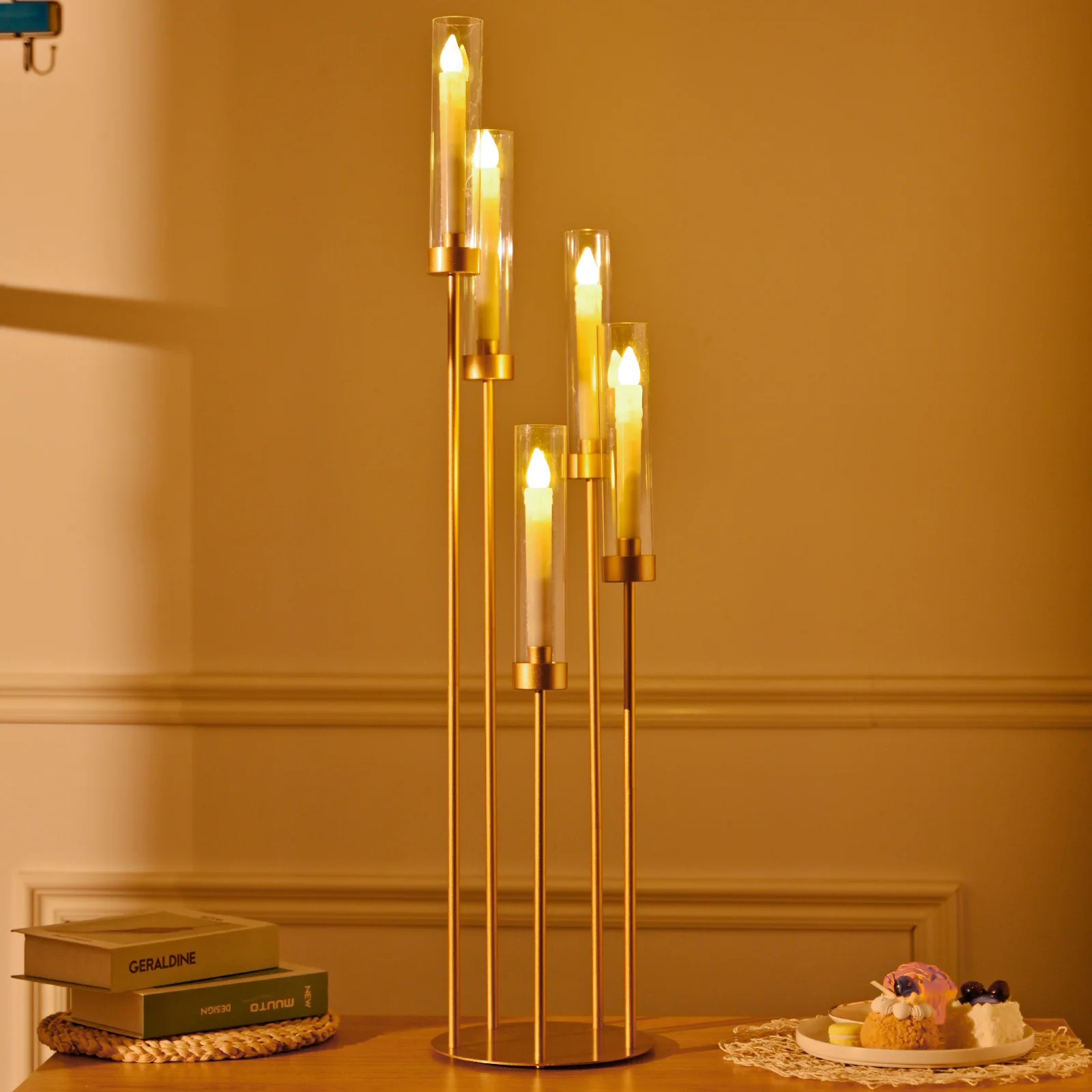 Tall gold candle holders arranged for event decor