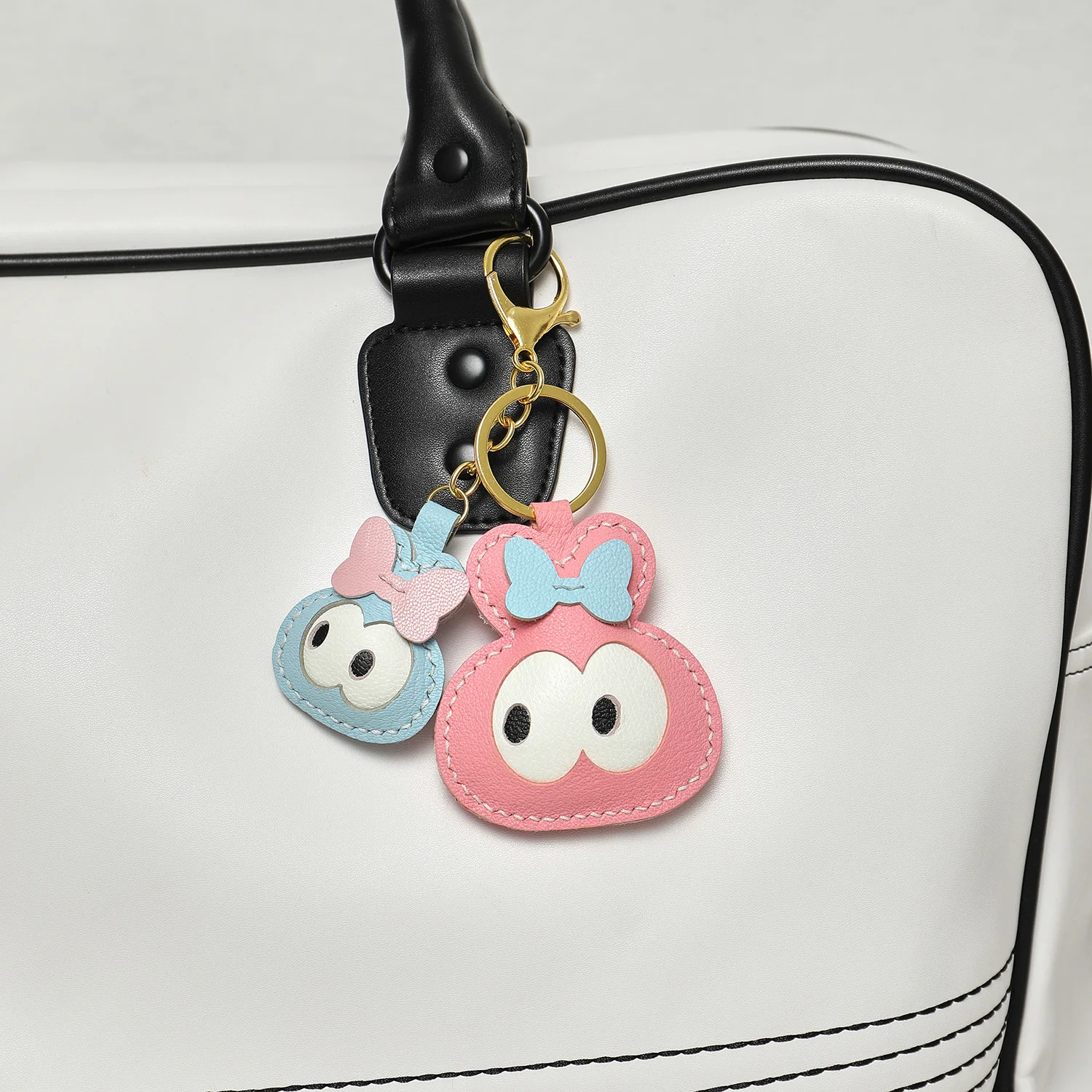 Leather bunny bag charm attached to handbag